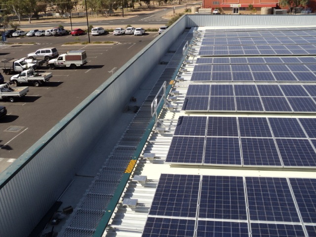 Roof walkway used to gain access to solar panels close to edge of building